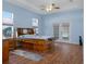 Main bedroom with light blue walls, wood flooring, and access to the pool at 456 Diamond Dr, Spring Hill, FL 34609