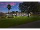Beautiful home with a large yard, three-car garage, and mature landscaping at 456 Diamond Dr, Spring Hill, FL 34609