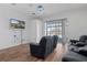 Gathering room with wood flooring, large screen TV and access to pool area at 456 Diamond Dr, Spring Hill, FL 34609