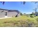 Backyard of a mobile home with a pond view and partial fence at 4853 Blanco Dr, Zephyrhills, FL 33541