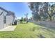 Landscaped backyard of a mobile home with a wooden fence and trees at 4853 Blanco Dr, Zephyrhills, FL 33541