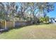 Large backyard with a wooden fence and lush landscaping at 4853 Blanco Dr, Zephyrhills, FL 33541