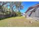 Spacious backyard with a wooden fence and mature trees at 4853 Blanco Dr, Zephyrhills, FL 33541