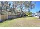 Backyard view showing a wooden fence and green grass at 4853 Blanco Dr, Zephyrhills, FL 33541