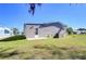 Side yard of a mobile home with a grassy area and partial view of neighboring homes at 4853 Blanco Dr, Zephyrhills, FL 33541