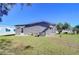 Backyard of a mobile home, showcasing the exterior and AC unit at 4853 Blanco Dr, Zephyrhills, FL 33541