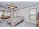 Bedroom with ceiling fan and mirrored closet doors at 4853 Blanco Dr, Zephyrhills, FL 33541