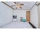 Bright bedroom with ceiling fan, TV stand, and exercise area at 4853 Blanco Dr, Zephyrhills, FL 33541