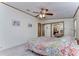 Bright bedroom with mirrored closet doors and ceiling fan at 4853 Blanco Dr, Zephyrhills, FL 33541