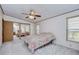 Bedroom with ceiling fan and mirrored closet doors at 4853 Blanco Dr, Zephyrhills, FL 33541