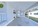 Covered carport with adjacent seating area and home entrance at 4853 Blanco Dr, Zephyrhills, FL 33541