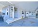 Covered carport with adjacent seating area and home entrance at 4853 Blanco Dr, Zephyrhills, FL 33541