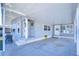 Covered carport with adjacent seating area and home entrance at 4853 Blanco Dr, Zephyrhills, FL 33541