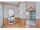 Bright entryway with wood flooring and view into the kitchen at 4853 Blanco Dr, Zephyrhills, FL 33541