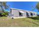 Gray mobile home exterior with white awnings and satellite dish at 4853 Blanco Dr, Zephyrhills, FL 33541