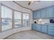 Kitchen with light blue cabinets and bay window at 4853 Blanco Dr, Zephyrhills, FL 33541