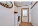 Laundry room with washer, dryer, cabinets, and exterior access at 4853 Blanco Dr, Zephyrhills, FL 33541