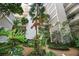 Ground level view of a tropical garden with walkways and building exterior at 500 N Osceola Ave # 406, Clearwater, FL 33755