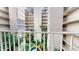 Lush courtyard view from condo balcony, featuring tropical plants and fountain at 500 N Osceola Ave # 406, Clearwater, FL 33755