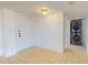 Clean entryway with tile floors and stacked washer/dryer at 500 N Osceola Ave # 406, Clearwater, FL 33755