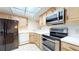 Modern kitchen featuring stainless steel appliances and light wood cabinets at 500 N Osceola Ave # 406, Clearwater, FL 33755