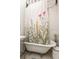 Bathroom with clawfoot tub, floral shower curtain, and pedestal sink at 561 11Th S Ave, St Petersburg, FL 33701