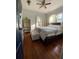 Bedroom with a king-size bed, ottoman, and hardwood floors at 561 11Th S Ave, St Petersburg, FL 33701