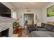 Cozy living room featuring a fireplace, sectional sofa, and hardwood floors at 561 11Th S Ave, St Petersburg, FL 33701