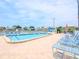 Inviting community pool with blue lounge chairs at 6025 Shore S Blvd # 409, Gulfport, FL 33707