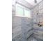 Walk-in shower with stylish tile and a built-in shelf at 6025 Shore S Blvd # 409, Gulfport, FL 33707