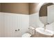 Small powder room with a modern pedestal sink and white shiplap walls at 6136 Jensen View Ave, Apollo Beach, FL 33572