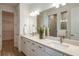 Elegant bathroom with double vanity, quartz countertops, and a walk-in shower at 6136 Jensen View Ave, Apollo Beach, FL 33572