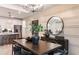 Elegant dining room with dark wood table and statement chandelier at 6136 Jensen View Ave, Apollo Beach, FL 33572