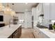 Modern kitchen with white cabinets, large island, and stainless steel appliances at 6136 Jensen View Ave, Apollo Beach, FL 33572