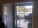 Sliding glass doors leading to a screened-in patio at 6548 Castle Green Pl, Zephyrhills, FL 33541