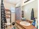 Bathroom with sink, shower, and shelving unit at 7029 Oakwood Dr, New Port Richey, FL 34652
