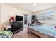Bedroom with a dresser, TV, and sliding door to patio at 7029 Oakwood Dr, New Port Richey, FL 34652