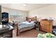 Spacious bedroom with wood-framed bed and dresser at 7029 Oakwood Dr, New Port Richey, FL 34652