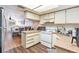 Bright kitchen features white appliances and ample counter space at 7029 Oakwood Dr, New Port Richey, FL 34652