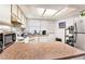 Kitchen with laminate flooring, white cabinets, and appliances at 7029 Oakwood Dr, New Port Richey, FL 34652