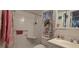 Bathroom with walk-in shower, shelves, and floral decor at 801 83Rd N Ave # 107, St Petersburg, FL 33702