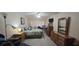 Bedroom with large bed, dresser, and work desk at 801 83Rd N Ave # 107, St Petersburg, FL 33702