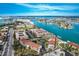 Breathtaking aerial view showcasing intercoastal community, boat docks, and waterfront living at 8711 Blind Pass Rd # 307A, St Pete Beach, FL 33706