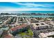 Aerial view of bayside community with tennis courts, ponds, and waterfront location at 8711 Blind Pass Rd # 307A, St Pete Beach, FL 33706