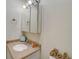 Clean bathroom with single sink vanity and medicine cabinet at 8711 Blind Pass Rd # 307A, St Pete Beach, FL 33706
