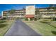 Well-maintained Bridgehampton Bay building exterior with lush landscaping and ample parking at 8711 Blind Pass Rd # 307A, St Pete Beach, FL 33706