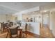 Open dining area with glass table and kitchen views at 8711 Blind Pass Rd # 307A, St Pete Beach, FL 33706