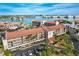 Aerial view of Bridgehampton Bay condos, with bay views, mature palms, and parking at 8711 Blind Pass Rd # 307A, St Pete Beach, FL 33706