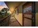 Residential hallway with access to condo unit, offering a glimpse of sunset at 8711 Blind Pass Rd # 307A, St Pete Beach, FL 33706