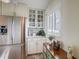 White kitchen cabinets, granite countertops, and stainless steel appliances at 8711 Blind Pass Rd # 307A, St Pete Beach, FL 33706